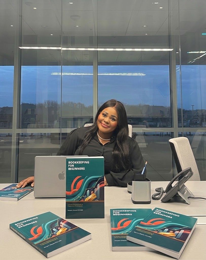 Maryann at a desk with copies of Bookkeeping for Beginners